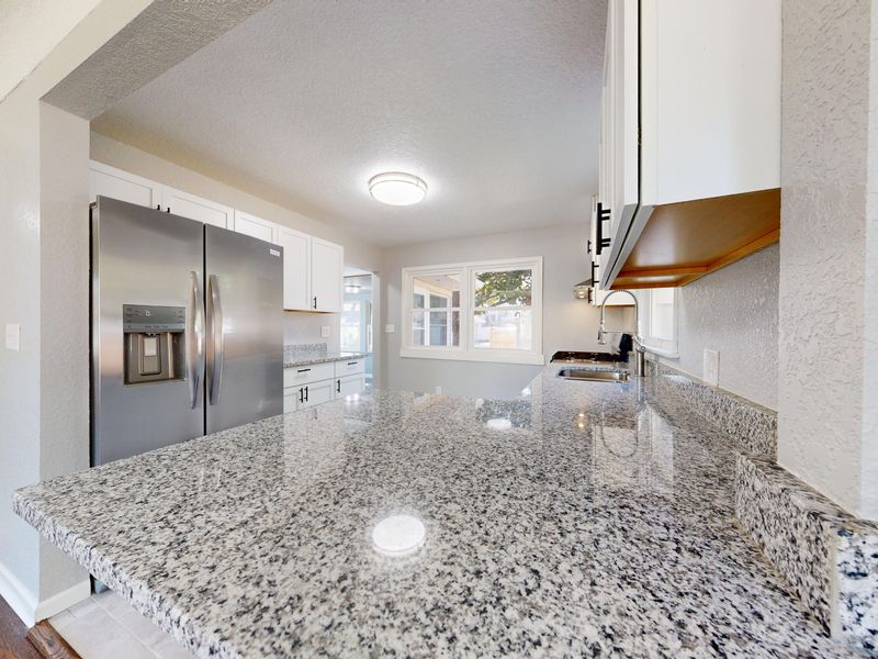 Kitchen renovation with new countertops and cabinets by Rework Construction